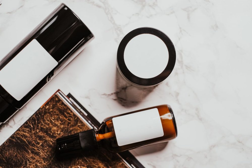 Unbranded skincare containers illustrate reviewing each product in a recurring acne routine. Photo by Vie Studio on Pexels.